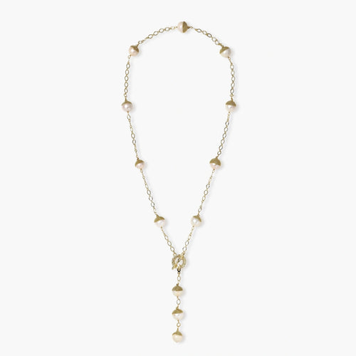 Gold-plated lariat necklace with baroque pearls and textured caps on cream background, showing adjustable Y-shaped design.