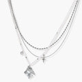 Multi-strand layered necklace set with silver chains, white pearls, star charm, heart pendant, and ornate decorative piece