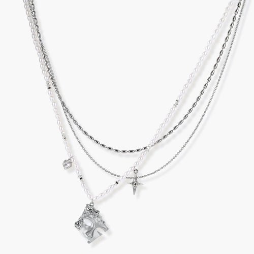 Multi-strand layered necklace set with silver chains, white pearls, star charm, heart pendant, and ornate decorative piece