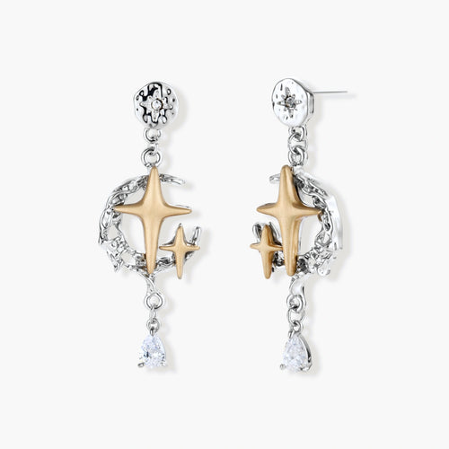 Two-tone star earrings with gold celestial motifs, silver chains, and clear crystal droplets on white background.
