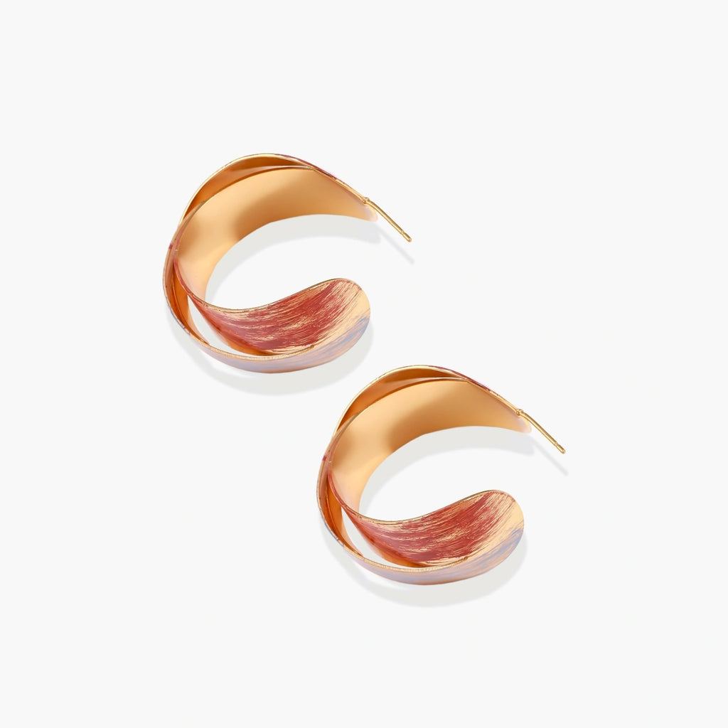 Sculptural gold-plated hoop earrings with diagonal purple and coral enamel stripes in twisted ribbon design