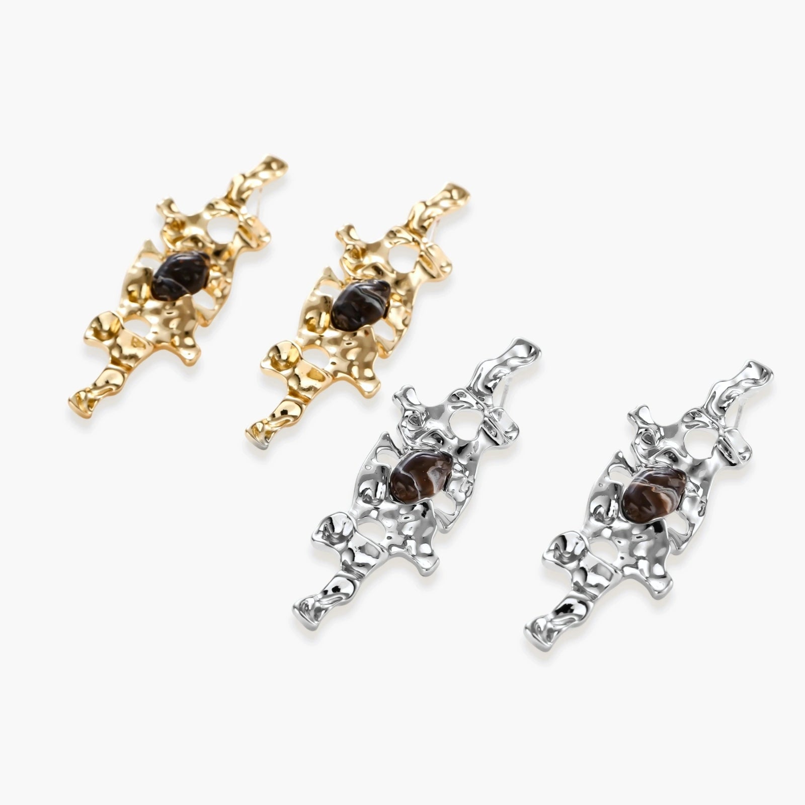 Flowing silver-toned earrings with organic liquid shapes and embedded brown resin stones on white background.