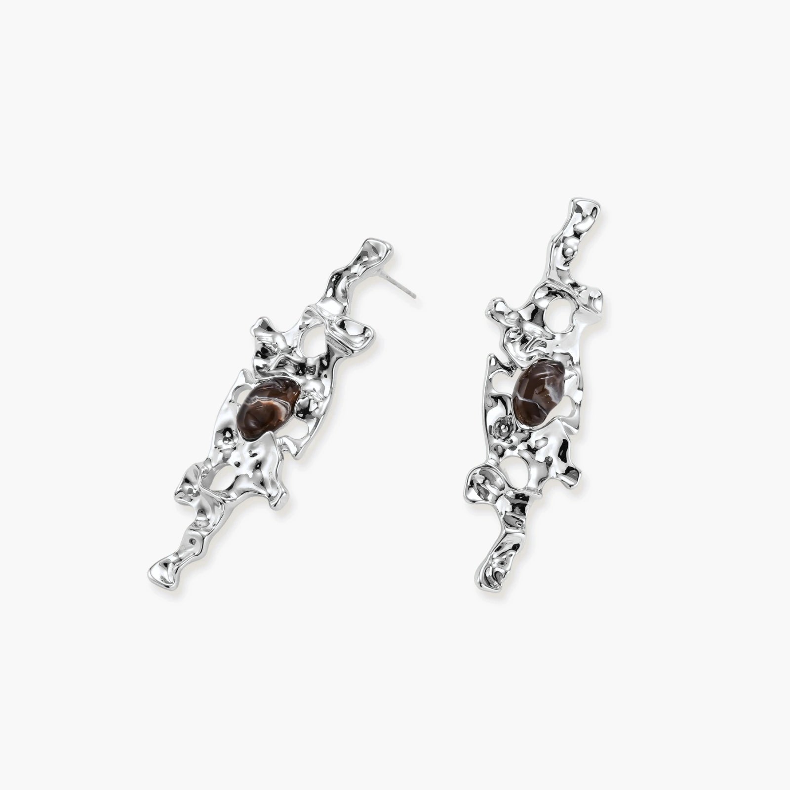 Flowing silver-toned earrings with organic liquid shapes and embedded brown resin stones on white background.