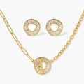 Gold-plated necklace and earring set with circular CZ crystal pendants featuring radial design on cream background