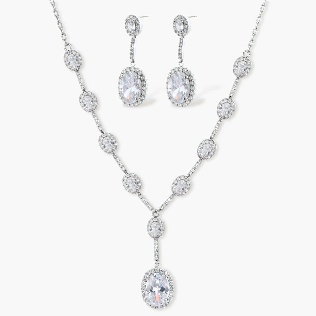 Elegant white gold plated jewelry set with oval cubic zirconia stones in halo settings, featuring Y-necklace and drop earrings.