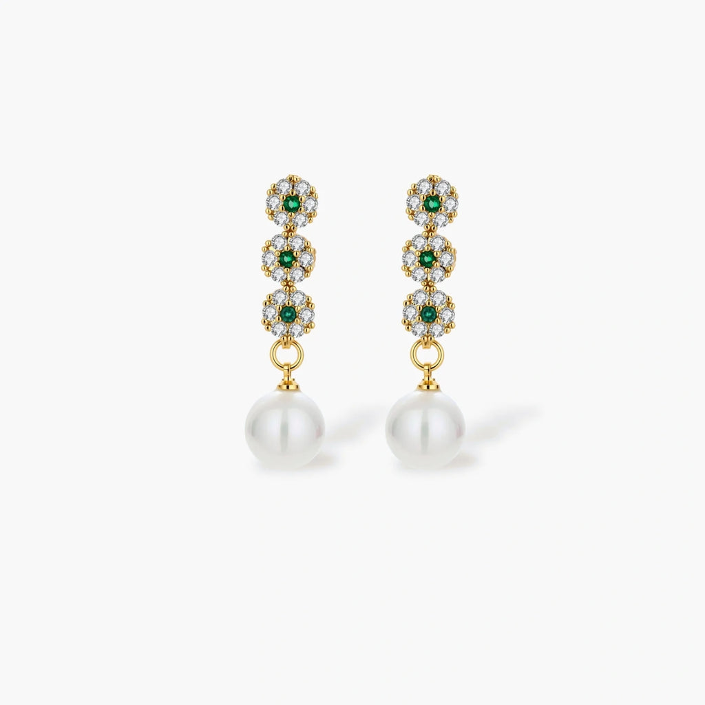 Gold-plated jewelry set with green cubic zirconia floral motifs, featuring matching necklace and pearl drop earrings