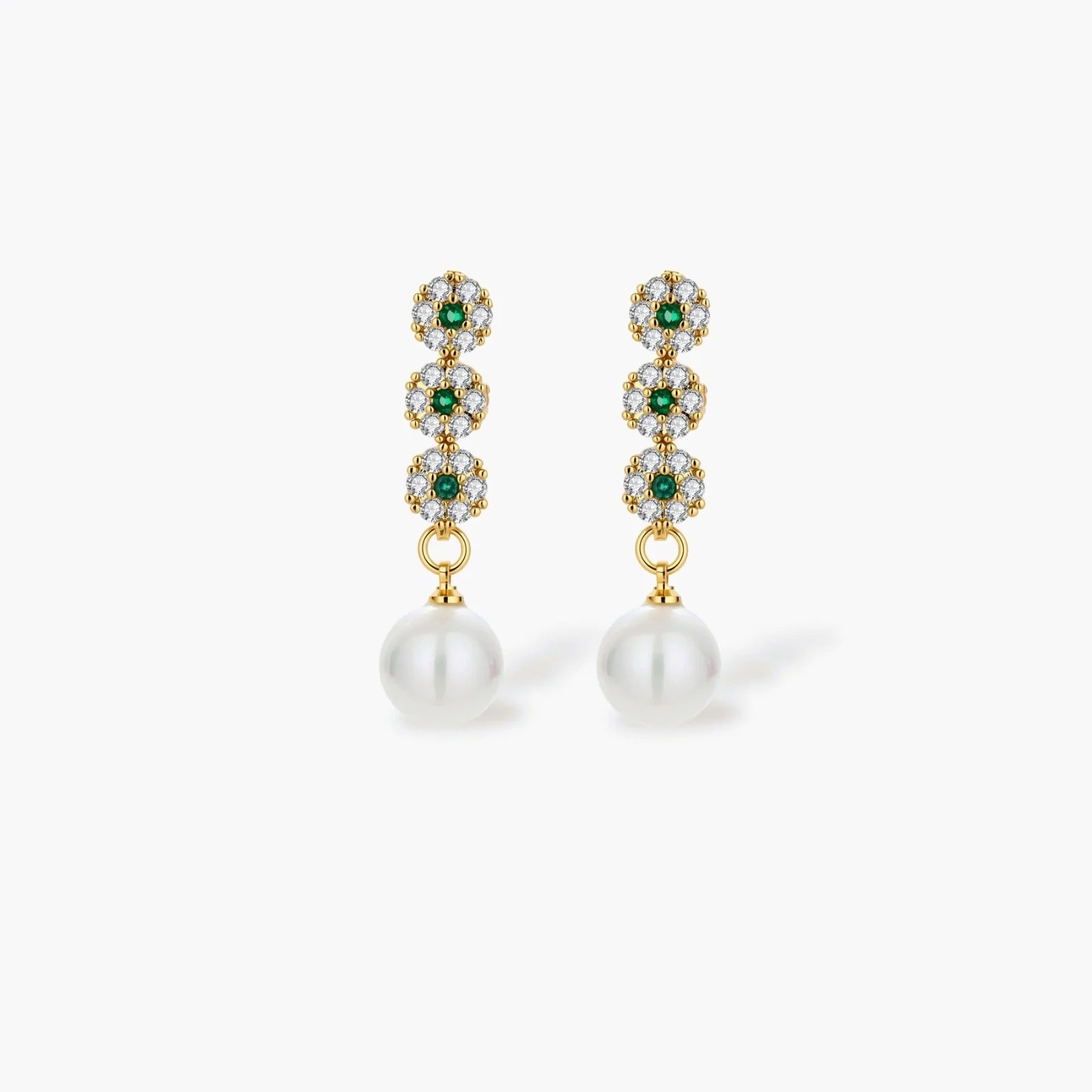 Gold-plated jewelry set with green cubic zirconia floral motifs, featuring matching necklace and pearl drop earrings