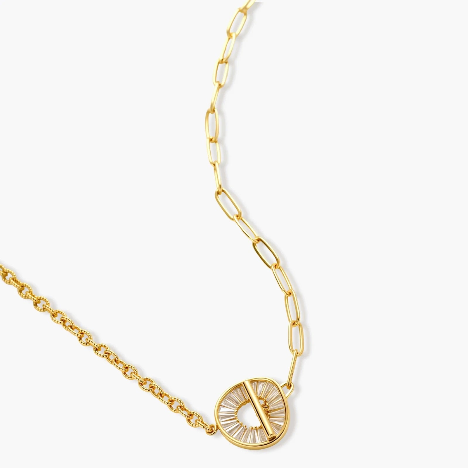 Gold-plated necklace and earring set with circular CZ crystal pendants featuring radial design on cream background