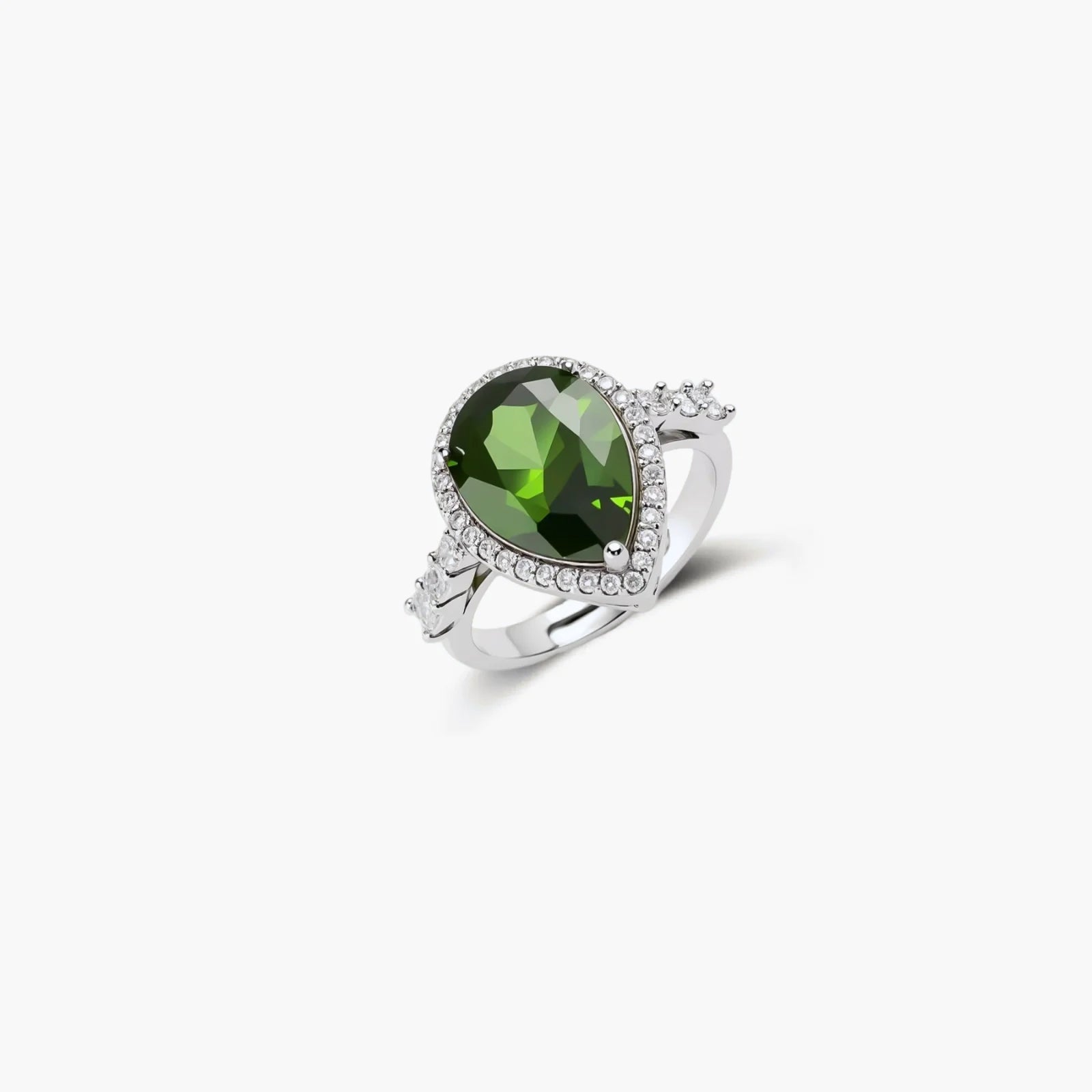 White gold plated jewelry set with green teardrop gemstones and cubic zirconia halos on cream background.