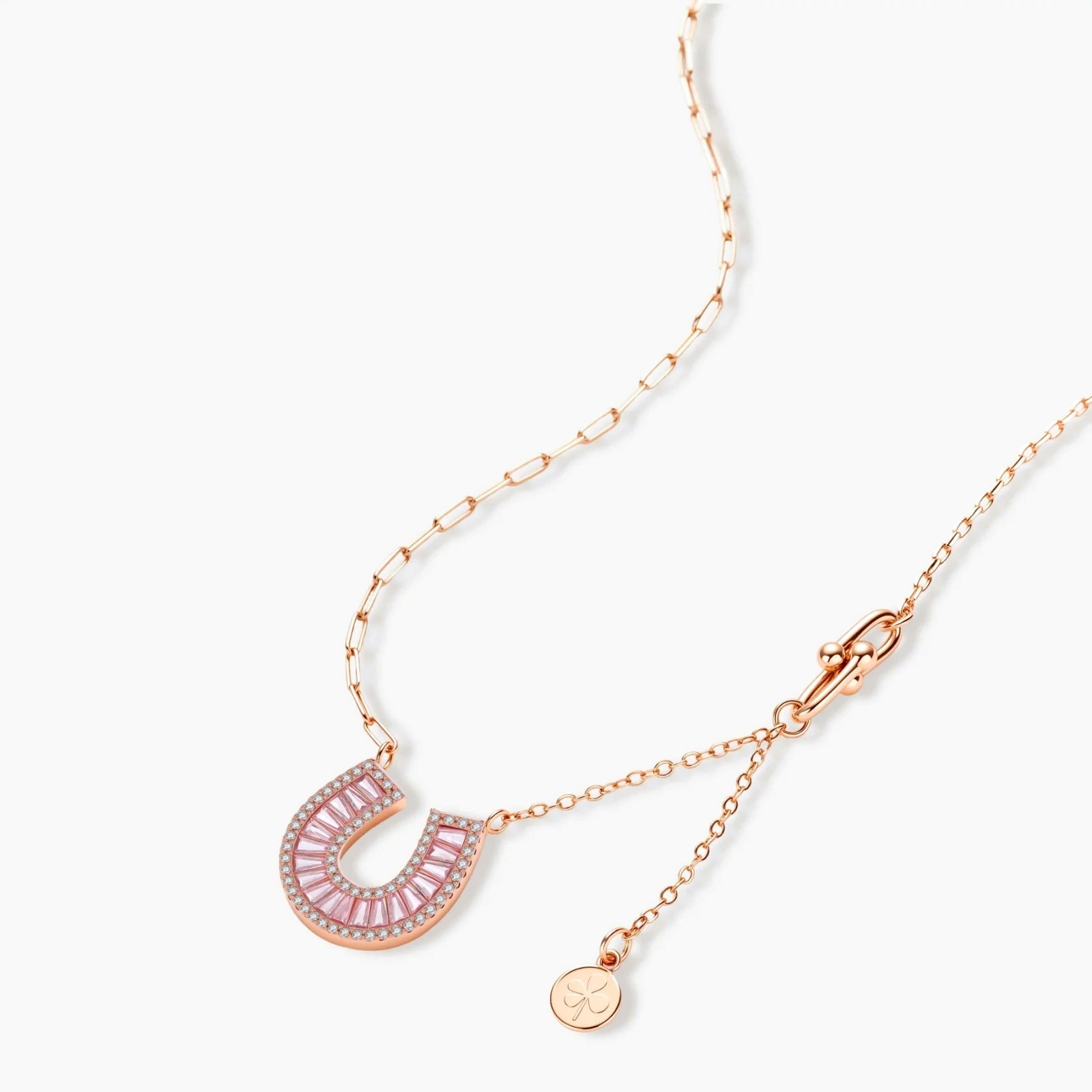 Sparkling horseshoe-shaped jewelry set with AAA cubic zirconia in gold-plated and white gold finishes on cream background.