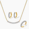 Gold-plated curved necklace, hoop earrings, and adjustable ring with pavé cubic zirconia stones on cream background.