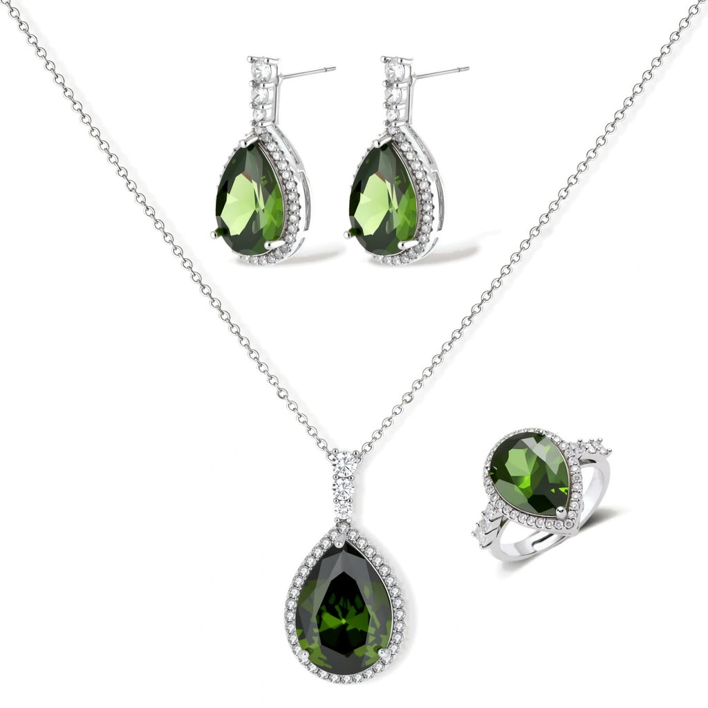 White gold plated jewelry set with green teardrop gemstones and cubic zirconia halos on cream background.