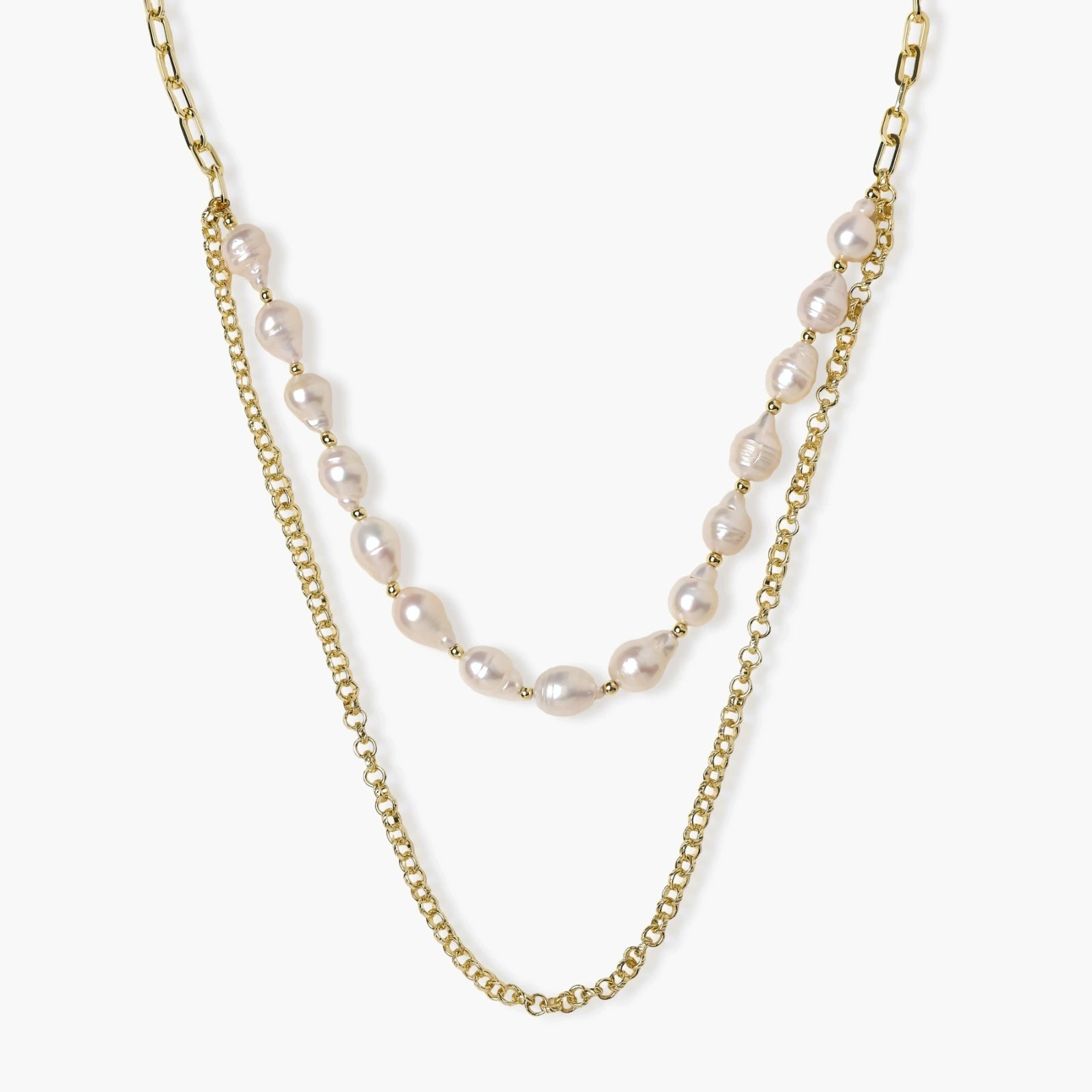 Layered gold chain necklace with organic baroque freshwater pearls and adjustable length on cream background