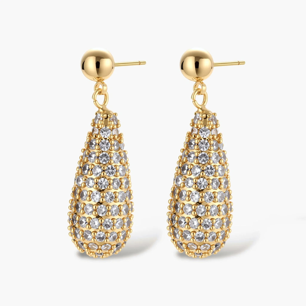 Gold-plated teardrop necklace and earrings covered in AAA cubic zirconia crystals on cream background.
