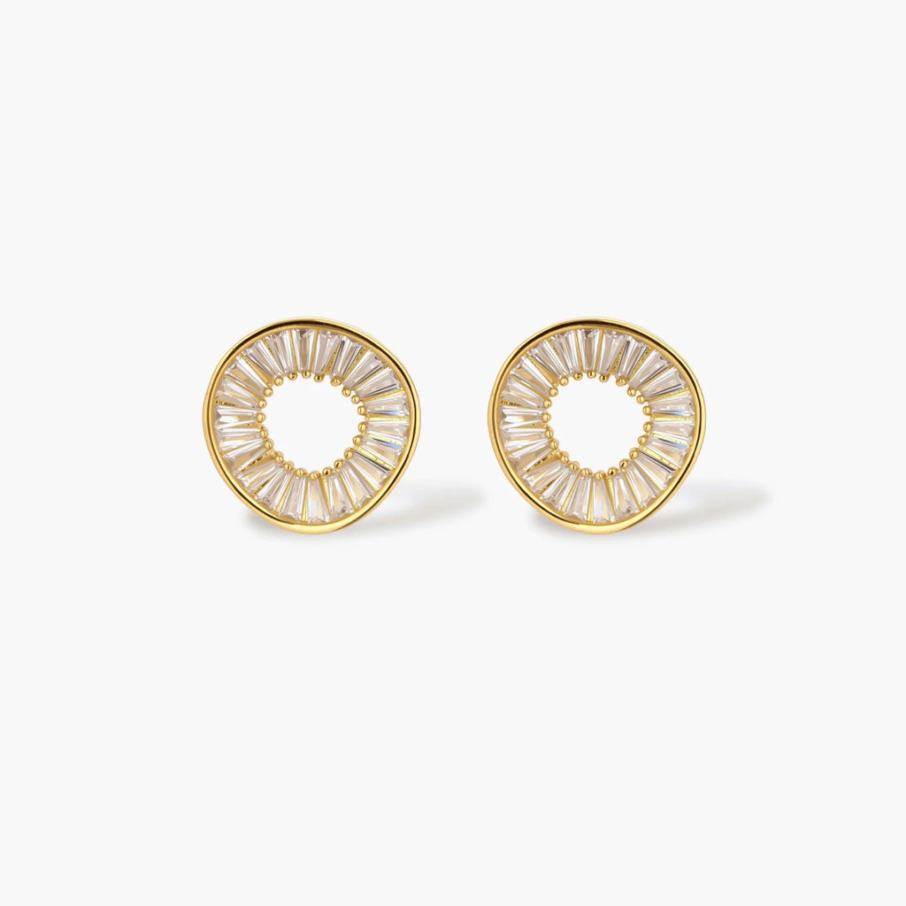 Gold-plated necklace and earring set with circular CZ crystal pendants featuring radial design on cream background