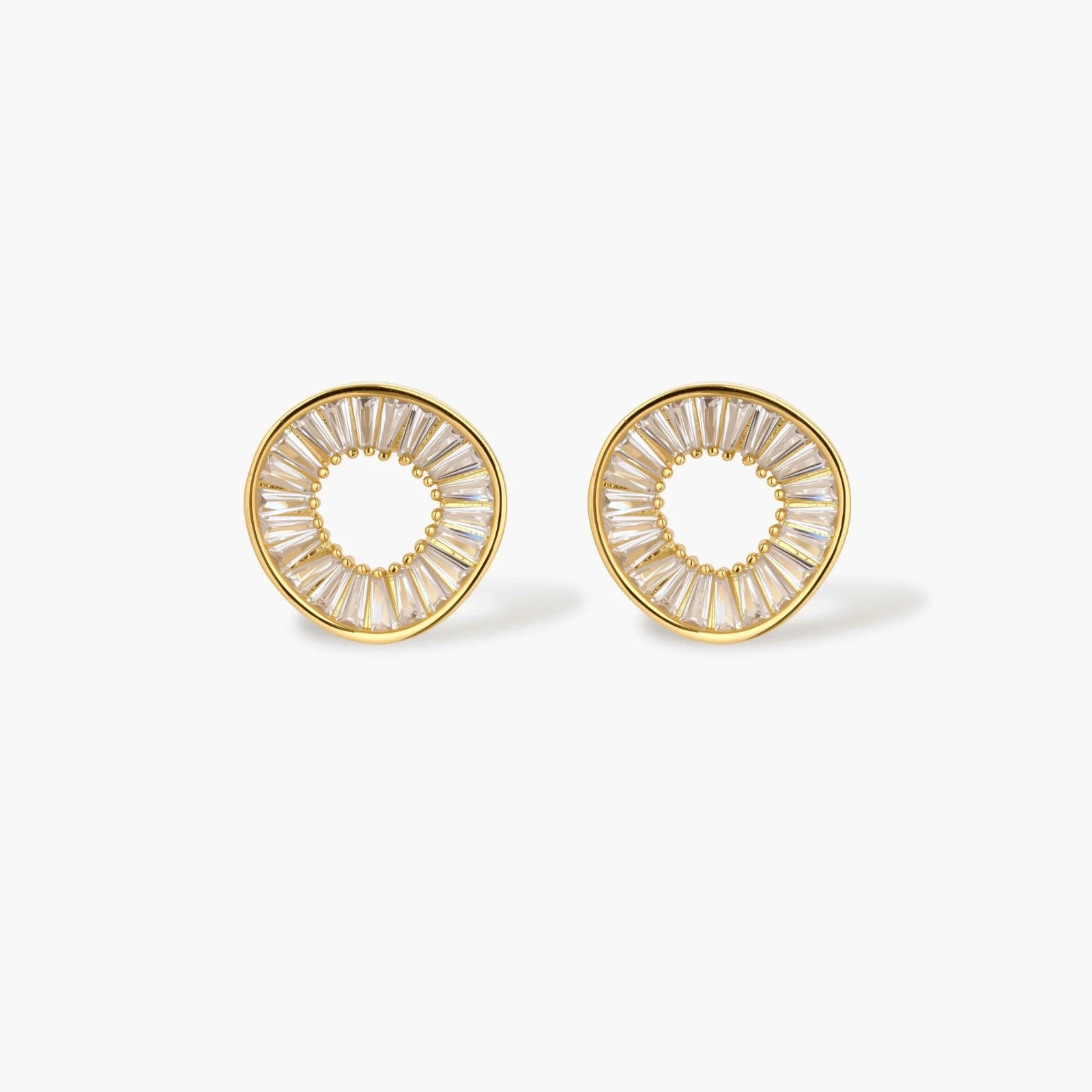 Gold-plated necklace and earring set with circular CZ crystal pendants featuring radial design on cream background