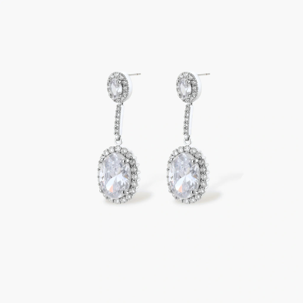Elegant white gold plated jewelry set with oval cubic zirconia stones in halo settings, featuring Y-necklace and drop earrings.