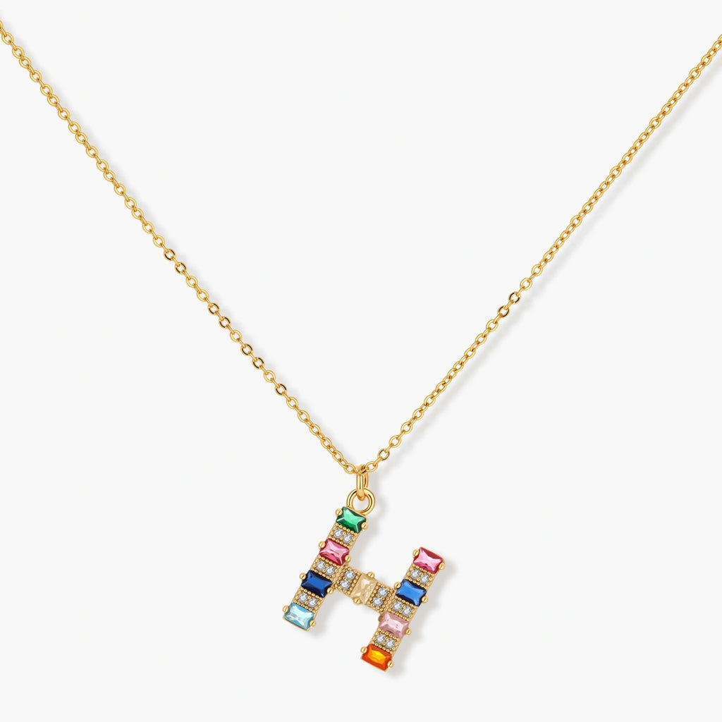 Gold-plated letter H jewelry set with multicolor zirconia stones in emerald cuts, showing necklace pendant and matching earrings