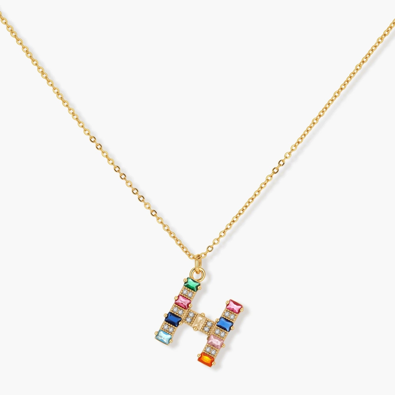 Gold-plated letter H jewelry set with multicolor zirconia stones in emerald cuts, showing necklace pendant and matching earrings