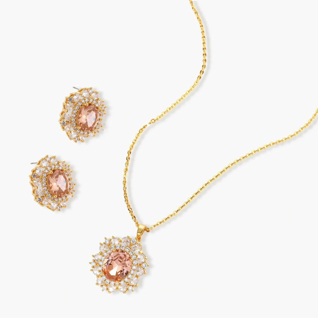 Ornate gold-plated jewelry set featuring peach center stone surrounded by clear AAA cubic zirconia crystals
