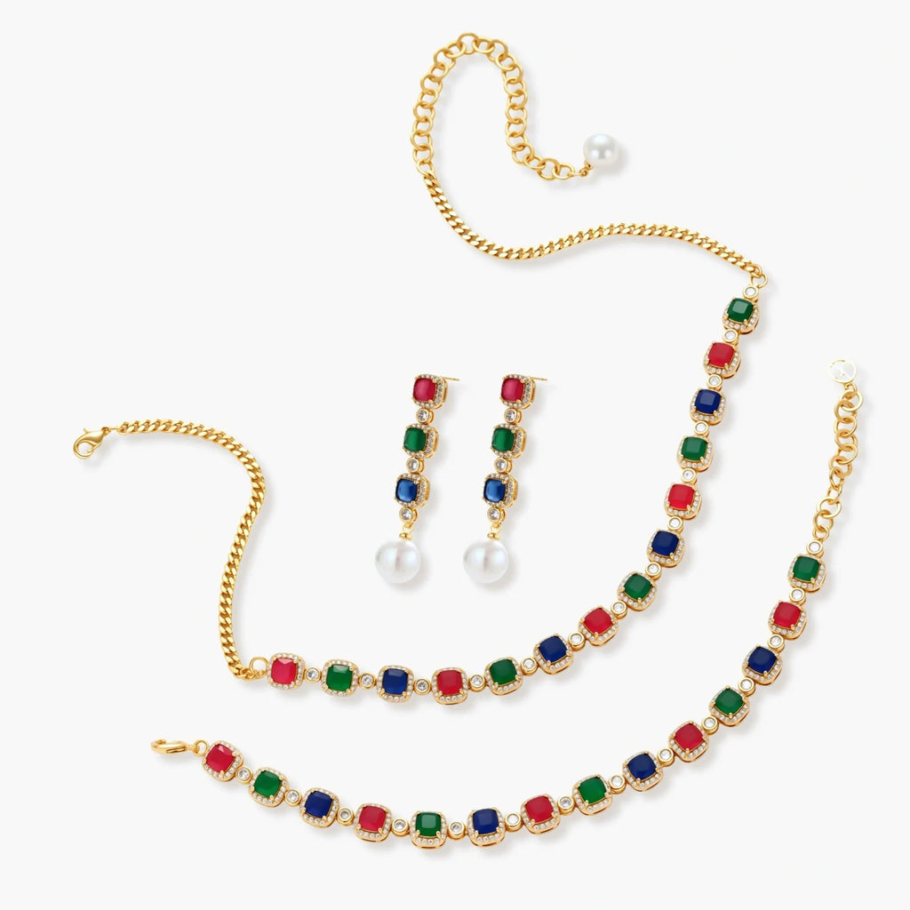 Gold-plated jewelry set with red, green, and blue cubic zirconia stones including necklace, bracelet, and drop earrings.
