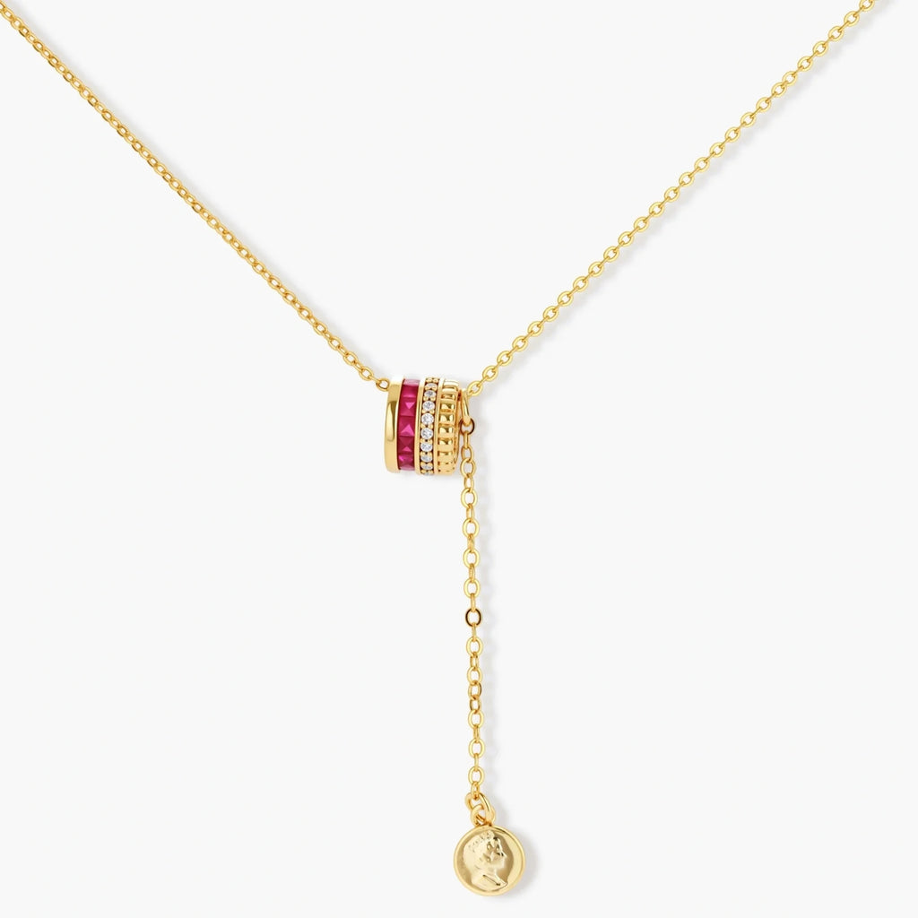 Three-piece jewelry set featuring 14K gold plated pieces with deep red cubic zirconia stones and clear crystals on cream background.