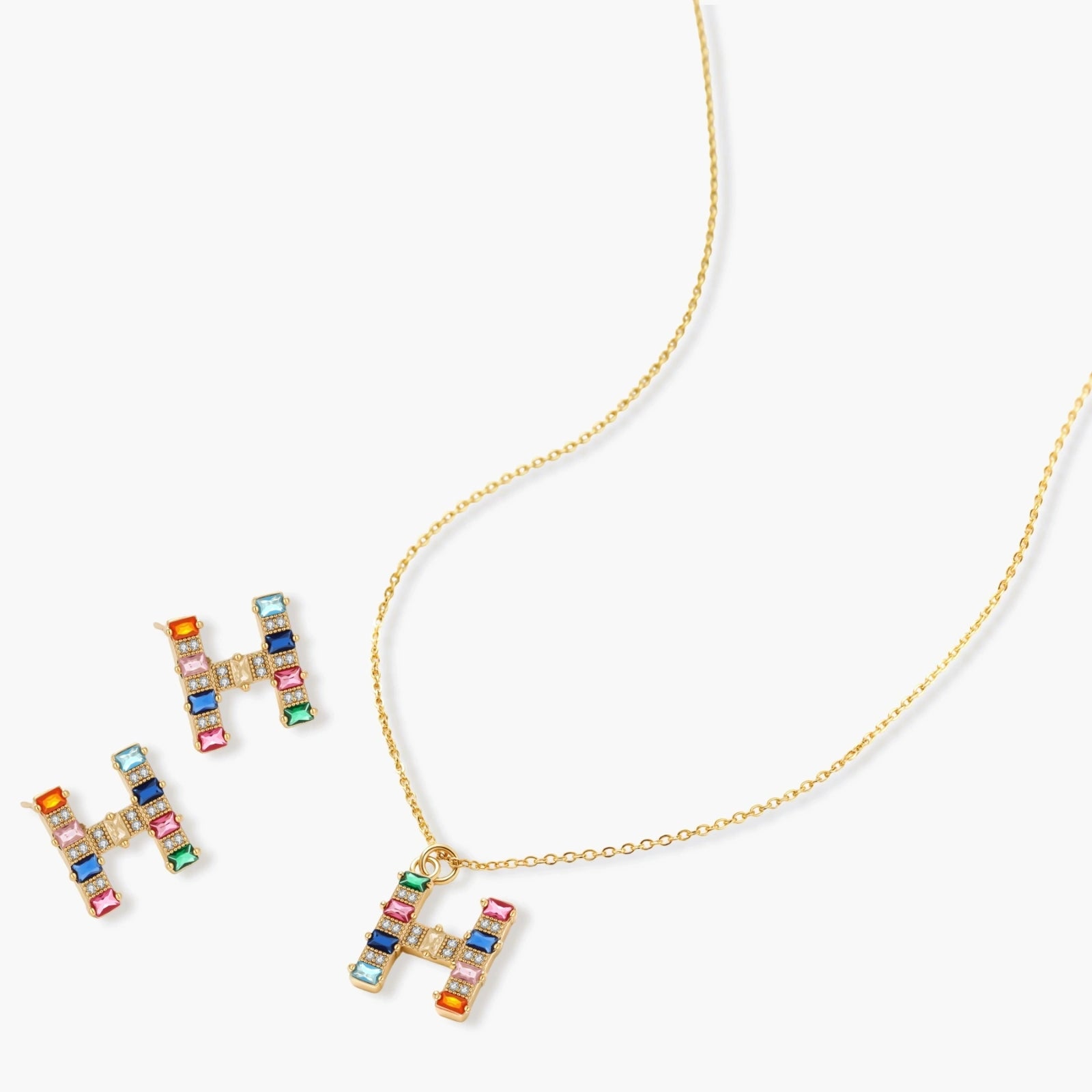 Gold-plated letter H jewelry set with multicolor zirconia stones in emerald cuts, showing necklace pendant and matching earrings