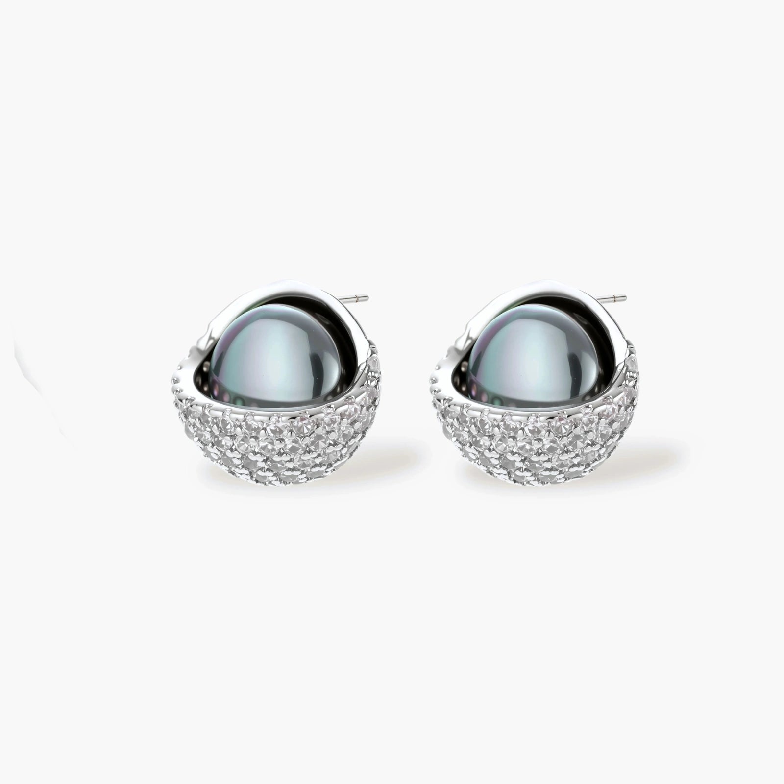 White gold plated spherical jewelry set with zirconia crystal pavé and dark lustrous centers on neutral background.